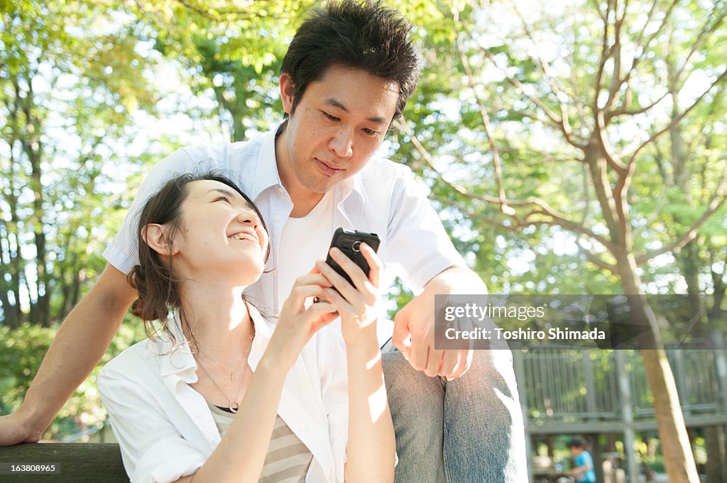 Japanese couple looking at smartphone