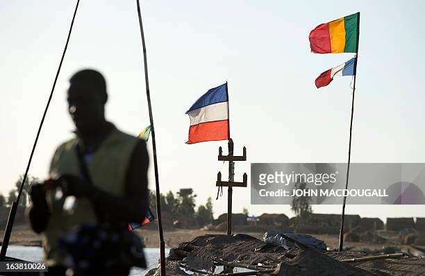 French and Malian flags flies on a so-called Pinasse boat on the river Bani, a branch of the river Niger, at the commercial port of the northern city...