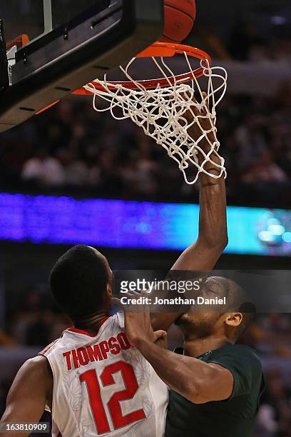 Sam Thompson of the Ohio State Buckeyes goes up for a rebound against Adreian Payne of the Michigan State Spartans during a semifinal game of the Big...
