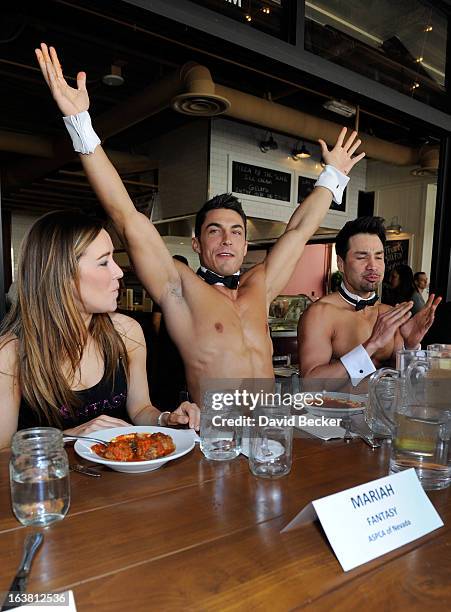 Mariah of the production show "Fantasy" and Chippendales dancers Jon Howes and Juan DeAngelo appear at the meatball eating contest at the Meatball...