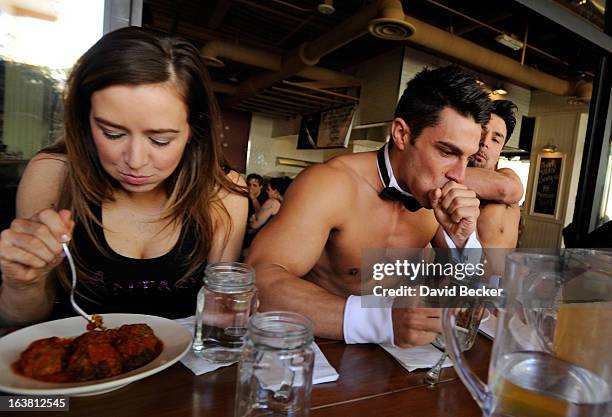 Mariah of the production show "Fantasy" and Chippendales dancers Jon Howes and Juan DeAngelo participate in the meatball eating contest at the...