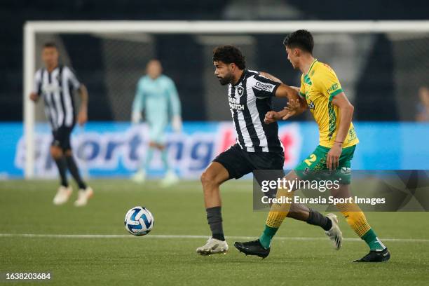 Diego Costa of Botafogo is chased by Julián Malatini of Defensa y Justicia during Copa CONMEBOL Sudamericana match between Botafogo and Defensa y...