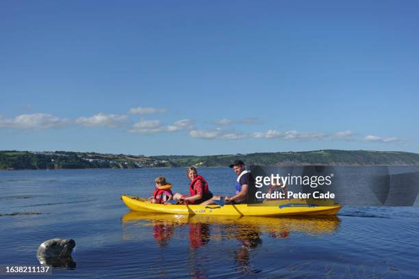 family canoeing in sea - life jacket photos stock pictures, royalty-free photos & images