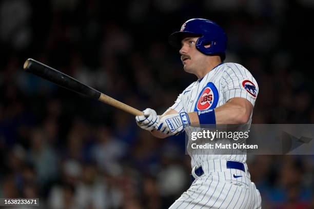 Patrick Wisdom of the Chicago Cubs watches the flight of a home run in a game against the Washington Nationals at Wrigley Field on July 18, 2023 in...