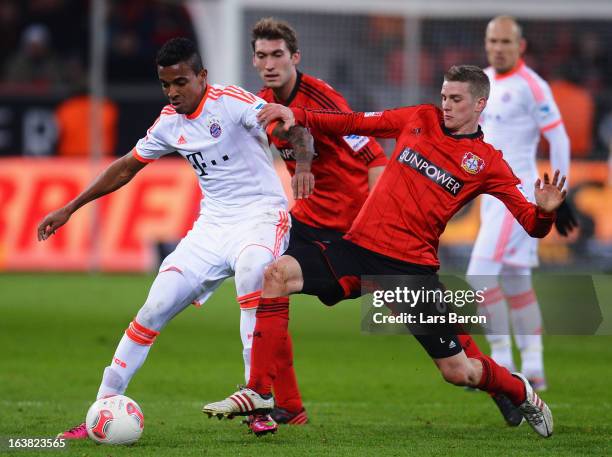 Luiz Gustavo of Muenchen is challenged by Lars Bender of Leverkusen during the Bundesliga match between Bayer 04 Leverkusen and FC Bayern Muenchen at...