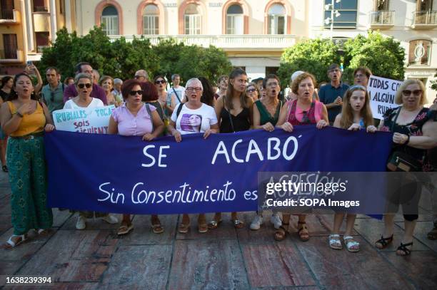 Protesters hold a large banner that says: "Se acabó. Sin consentimiento es agresión" as they take part in a protest in support to Spain's midfielder...