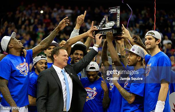 The Kansas Jayhawks and head coach Bill Self celebrate with the trophy after their 70-54 win over the Kansas State Wildcats during the Final of the...