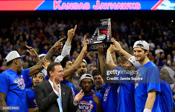 The Kansas Jayhawks and head coach Bill Self celebrate with the trophy after their 70-54 win over the Kansas State Wildcats during the Final of the...