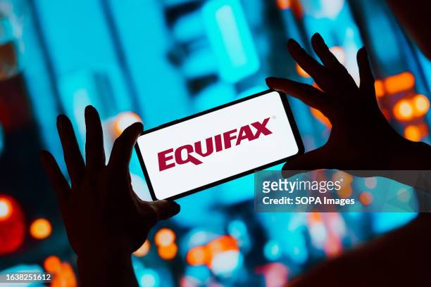 In this photo illustration, the Equifax logo is displayed on a smartphone screen.