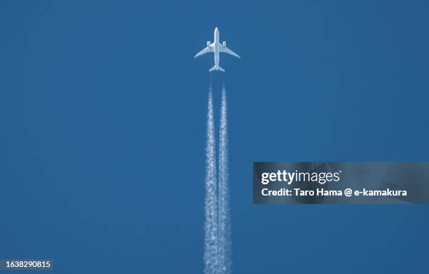 the airplane flying in the clear sky over kanagawa of japan - sunset contrail stock pictures, royalty-free photos & images