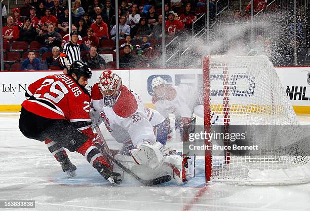 Carey Price of the Montreal Canadiens mkaes the second period save on Tom Kostopoulos of the New Jersey Devils at the Prudential Center on March 16,...