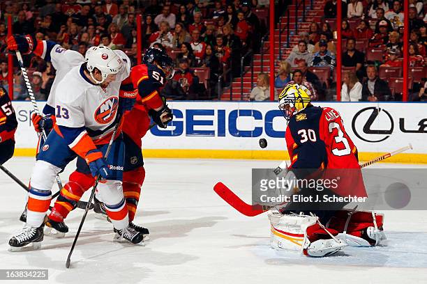 Goaltender Scott Clemmensen of the Florida Panthers defends the net with the help of teammate Brian Campbell against Colin McDonald of the New York...