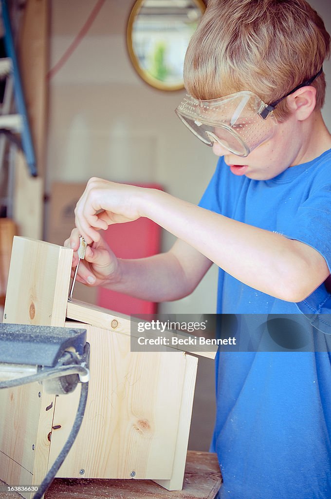 Boy making a birdhouse