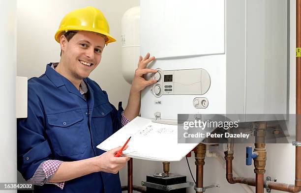 plumber with boiler - boiler stock-fotos und bilder