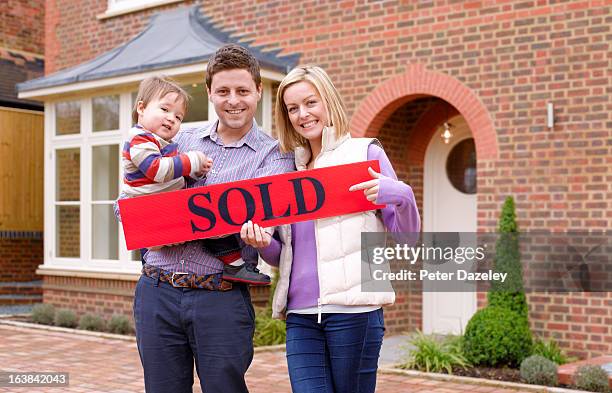 young family having bought new house - sold engels woord stockfoto's en -beelden