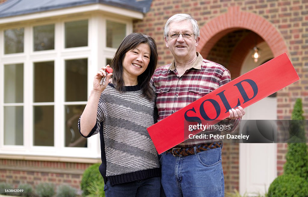 Mature couple with new house keys