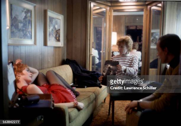 American actress Gwen Verdon shows a photograph to actress Shirley MacLaine during a break in the filming of 'Sweet Charity' at Universal Studios,...