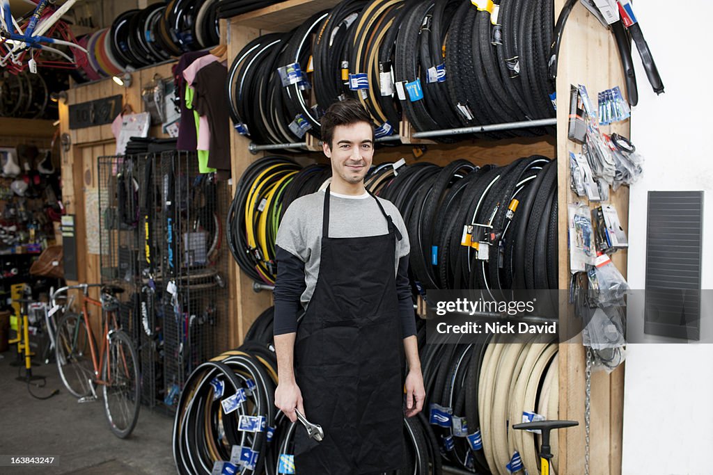 Portrait of a bike shop owner in his repair shop