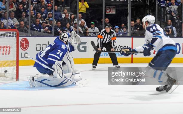 Zach Bogosian of the Winnipeg Jets scores the game-winning goal on James Reimer of the Toronto Maple Leafs during NHL shootout game action March 16,...
