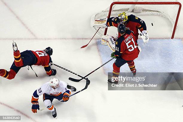 Casey Cizikas of the New York Islanders shoots and scores the game-winning goal against Goaltender Scott Clemmensen of the Florida Panthers at the...