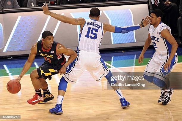 Pe'Shon Howard of the Maryland Terrapins dribbles against Josh Hairston and Quinn Cook of the Duke Blue Devils during the quarterfinals of the 2013...