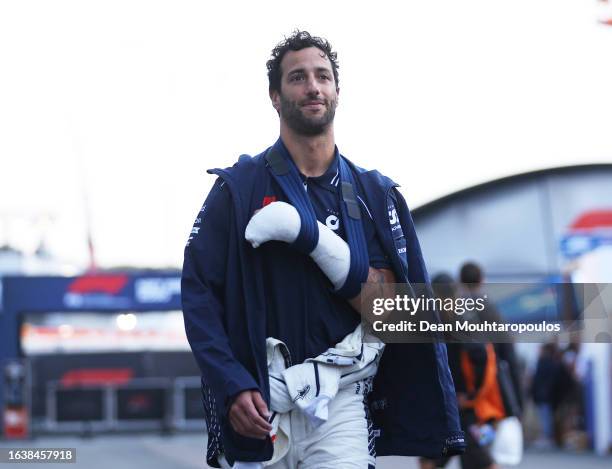 Daniel Ricciardo of Australia and Scuderia AlphaTauri wears a cast on his hand after crashing during practice which has ruled him out of competing in...