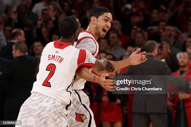 Russ Smith and Peyton Siva of the Louisville Cardinals celebrate after they won 78-61 against the Syracuse Orange during the final of the Big East...