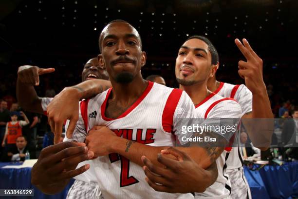 Russ Smith and Peyton Siva of the Louisville Cardinals celebrate after they won 78-61 against the Syracuse Orange during the final of the Big East...
