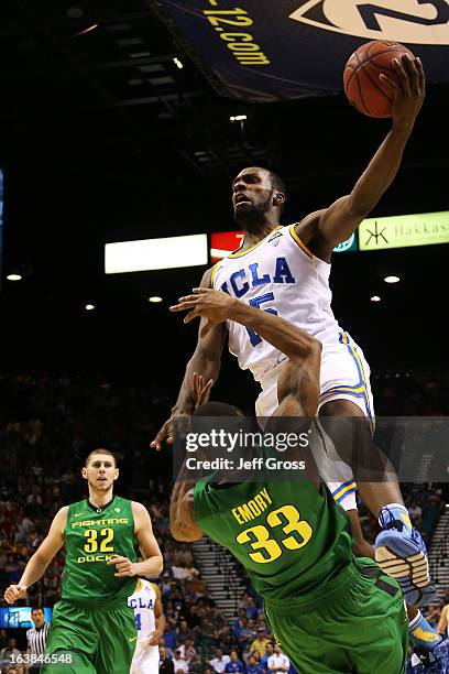 Shabazz Muhammad of the UCLA Bruins goes up against the defense of Carlos Emory of the Oregon Ducks in the first half of the Pac-12 Championship game...