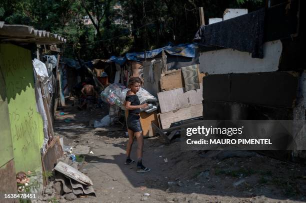 Homeless woman walks inside a homeless encampment at the Complexo do Lins favela, located in north Rio de Janeiro, Brazil on July 12, 2023. Thirteen...