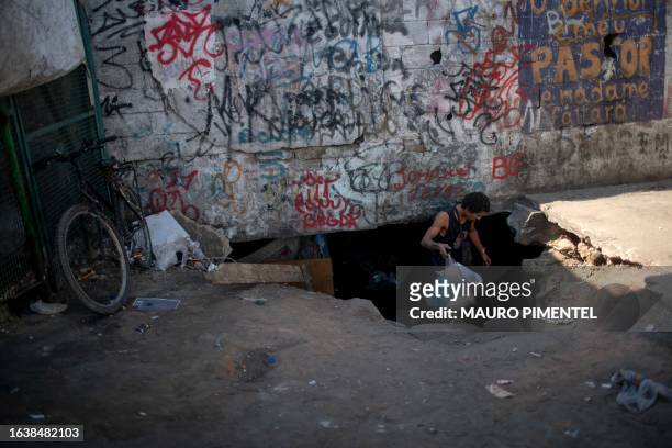 Homeless man gets inside a homeless encampment in the suburbs of Rio de Janeiro, Brazil on July 31, 2023. Thirteen teams from the municipal program...