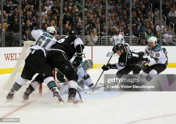 Kyle Clifford of the Los Angeles Kings jams the puck past goaltender Antti Niemi of the San Jose Sharks for a goal in the second period during the...