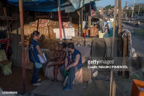 Social worker Raquel Martins and nurse Quesia Ferreira speaks with a pregnant homeless woman at the so called "Cracolandia" , a place where drug...