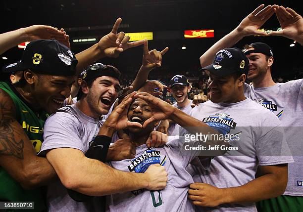 Johnathan Loyd of the Oregon Ducks celebrates with teammates after they defeated the UCLA Bruins 78 to 69 in the Pac-12 Championship game at MGM...