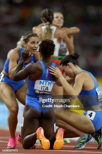 Team Italy reacts after competing in the Women's 4x100m Heats during day seven of the World Athletics Championships Budapest 2023 at National...