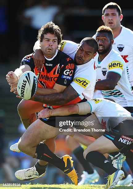 Matt Bell of the Tigers looks to off load to a team mate during the round two NRL match between the Wests Tigers and the Penrith Panthers at...