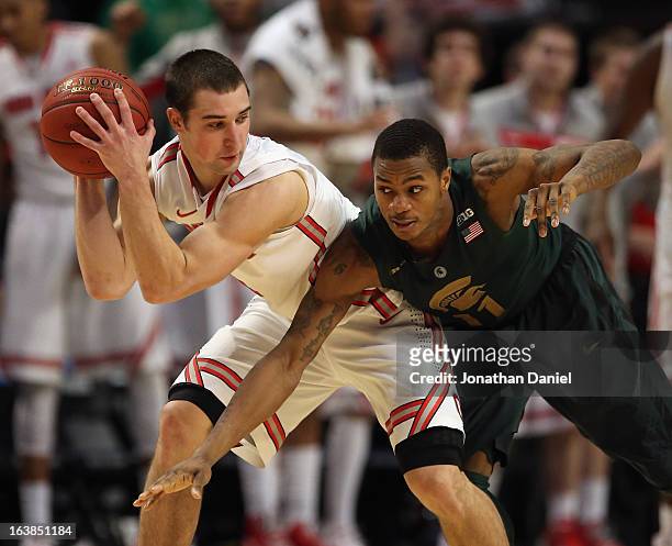 Aaron Craft of the Ohio State Buckeyes controls the ball against Keith Appling of the Michigan State Spartans during a semifinal game of the Big Ten...
