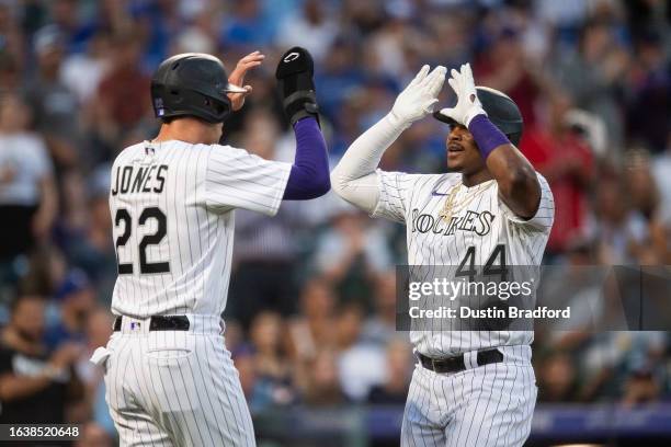 Elehuris Montero of the Colorado Rockies celebrates with Nolan Jones after hitting a two-run home run in the third inning against the Toronto Blue...