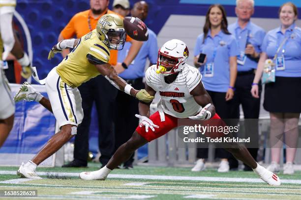 Kenyatta Watson II of the Georgia Tech Yellow Jackets interferes with the pass-catch attempt by Chris Bell of the Louisville Cardinals before the...