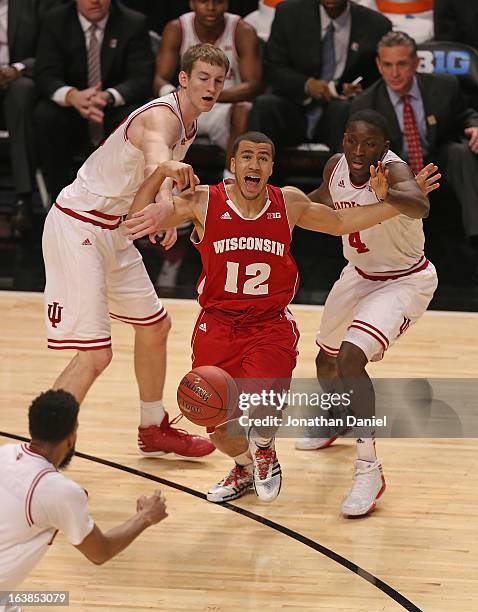 Treavon Jackson of the Wisconsin Badgers tries to drive between Cody Zeller and Victor Oladipo of the Indiana Hoosiers during a semifinal game of the...