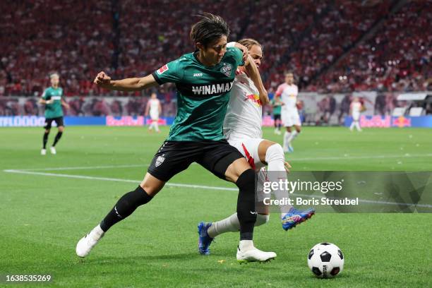 Hiroki Ito of VfB Stuttgart and Xavi Simons of RB Leipzig battle for possession during the Bundesliga match between RB Leipzig and VfB Stuttgart at...