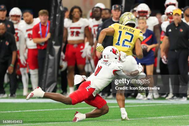 Louisville Cardinals running back Maurice Turner tackles Georgia Tech Yellow Jackets wide receiver Dominick Blaylock during the AFLAC Kickoff Game...