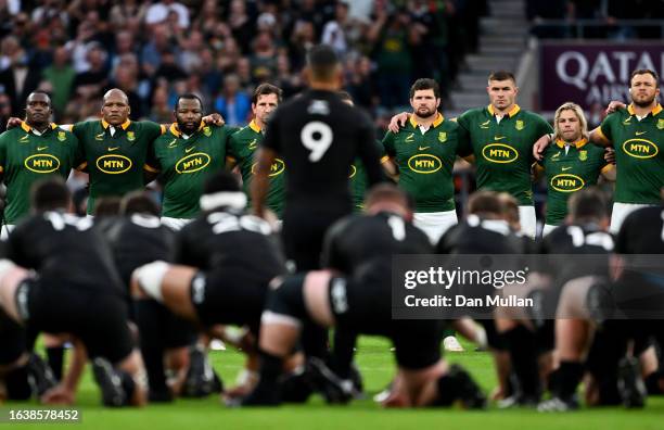 The players of South Africa watch on as Aaron Smith of New Zealand leads the Haka prior to kick-off ahead of the Summer International match between...