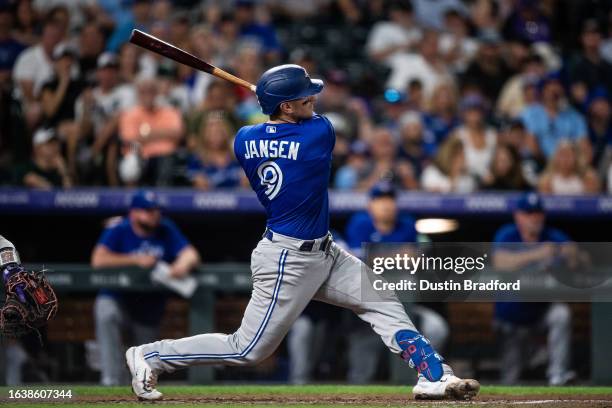 Danny Jansen of the Toronto Blue Jays hits a two-run home run in the sixth inning against the Colorado Rockies at Coors Field on September 1, 2023 in...