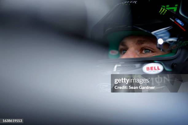 Riley Herbst, driver of the Monster Energy Ford, sits in his car during qualifying for the NASCAR Xfinity Series Wawa 250 powered by Coca-Cola at...