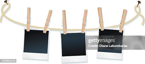 polaroids hanging on a clothesline - clothespin string stock illustrations