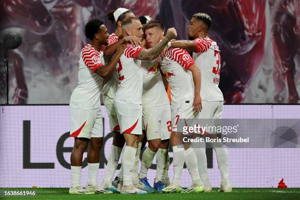 Dani Olmo of RB Leipzig celebrates with teammates after scoring the team's second goal during the Bundesliga match between RB Leipzig and VfB...