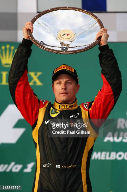 Kimi Raikkonen of Finland and Lotus celebrates on the podium after winning the Australian Formula One Grand Prix at the Albert Park Circuit on March...