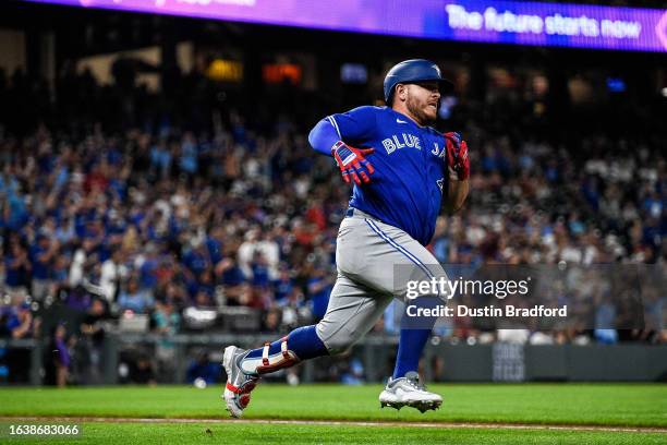 Alejandro Kirk of the Toronto Blue Jays runs after hitting a three-RBI double in the seventh inning against the Colorado Rockies at Coors Field on...