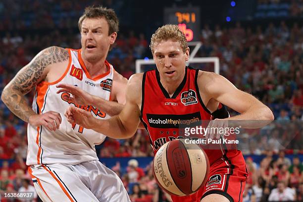 Shawn Redhage of the Wildcats looks to drive to the basket against Cameron Tragardh of the Taipans during the round 23 NBL match between the Perth...